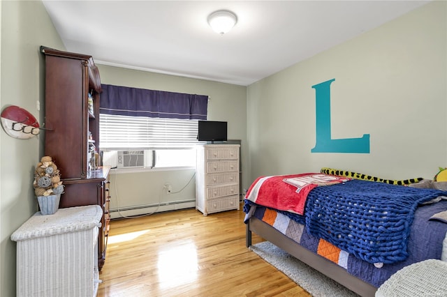 bedroom featuring light hardwood / wood-style floors and baseboard heating