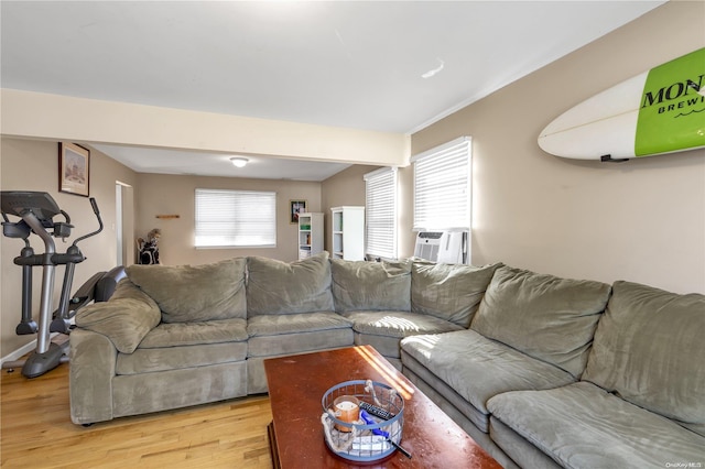 living room featuring cooling unit and light hardwood / wood-style flooring