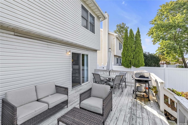 wooden deck featuring a grill and an outdoor living space