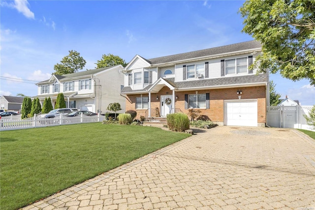 view of front facade with a front yard and a garage