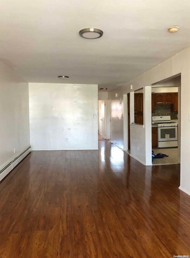 unfurnished room with dark hardwood / wood-style flooring and a baseboard radiator