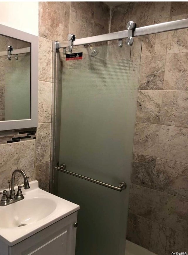 bathroom with vanity and an enclosed shower