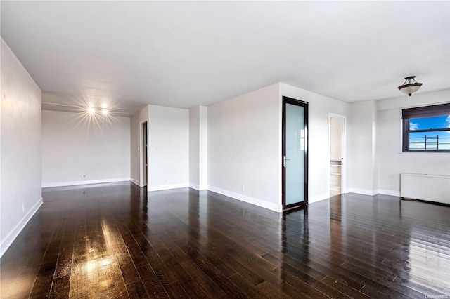 unfurnished living room with dark wood-type flooring