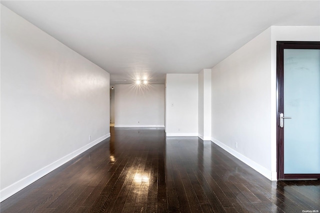 spare room featuring dark hardwood / wood-style flooring