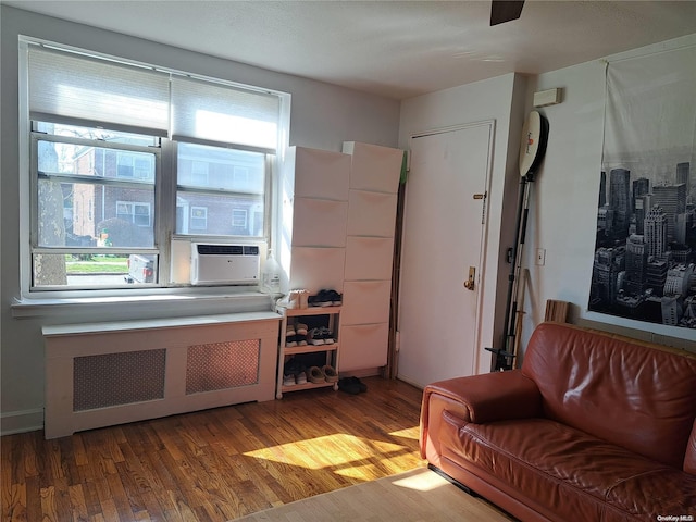 living room with hardwood / wood-style flooring and radiator heating unit