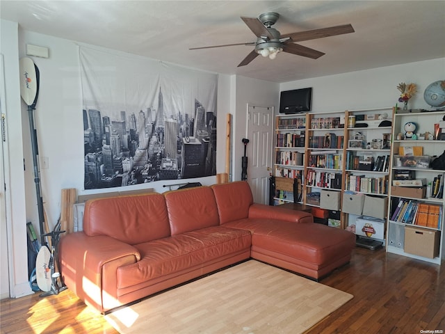 living room featuring hardwood / wood-style floors and ceiling fan