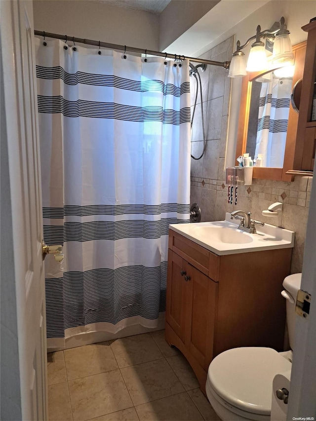 bathroom with tile patterned floors, backsplash, toilet, vanity, and tile walls