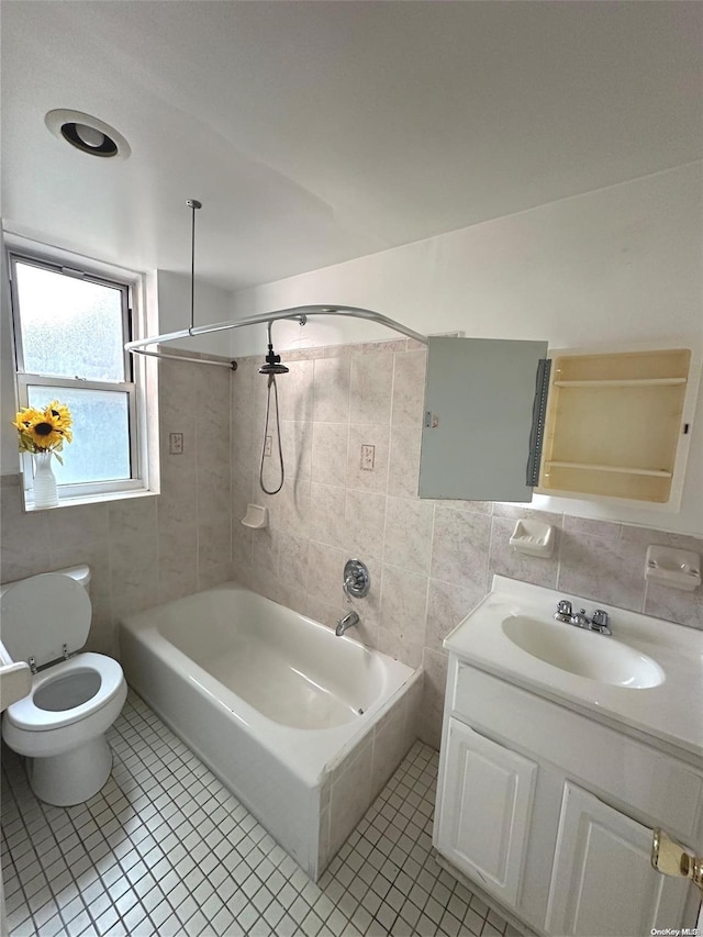 full bathroom featuring tile patterned flooring, bathing tub / shower combination, tile walls, and toilet