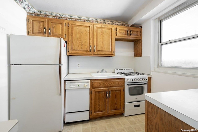 kitchen with sink and white appliances