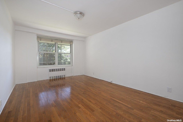 35-51 85th St Unit 3-L, Jackson Heights, NY 11372 - spare room featuring wood-type flooring and radiator heating unit