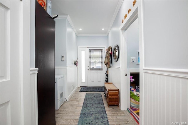 entryway featuring crown molding and light hardwood / wood-style floors