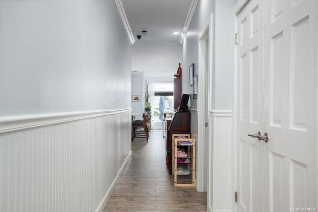 corridor with crown molding and wood-type flooring