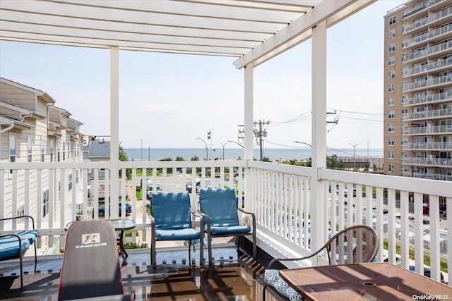 balcony with a pergola and a water view