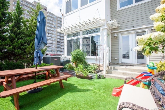 exterior space with a lawn and french doors