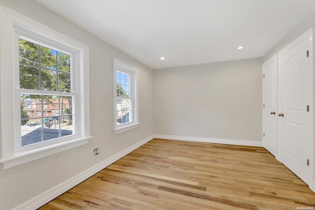 spare room with light wood-type flooring