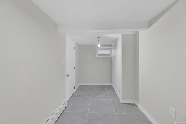 interior space with light tile patterned floors and baseboard heating