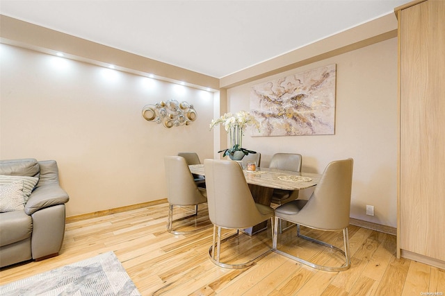 dining space with hardwood / wood-style flooring