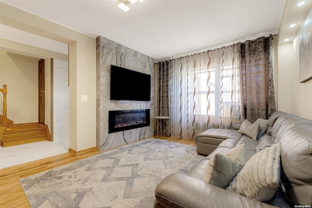 living room with wood-type flooring and a fireplace