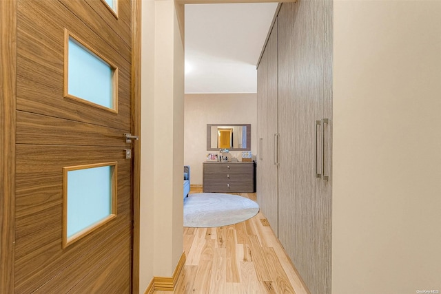 corridor with light wood-type flooring