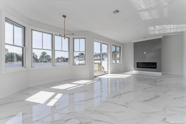 unfurnished living room featuring a notable chandelier and a high end fireplace