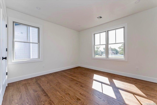 empty room with hardwood / wood-style floors