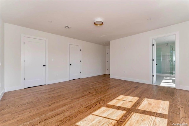 unfurnished room with light hardwood / wood-style flooring