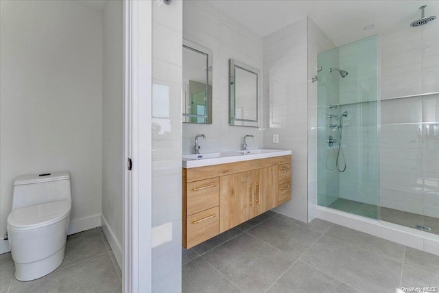 bathroom with tile patterned flooring, a tile shower, vanity, and toilet