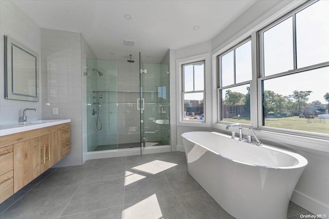 bathroom featuring tile patterned floors, vanity, and separate shower and tub