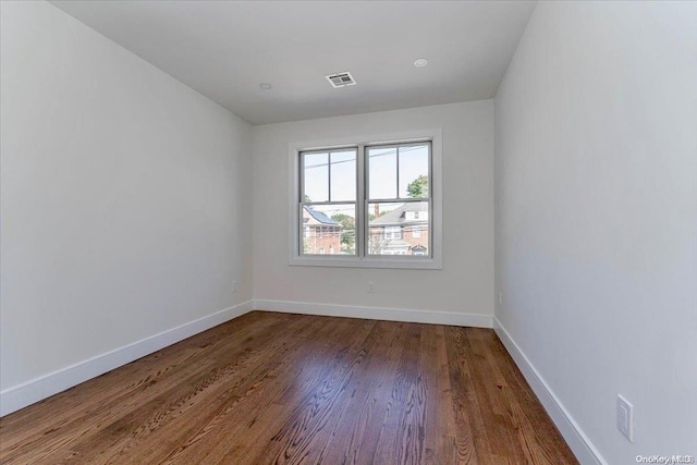 spare room with hardwood / wood-style flooring