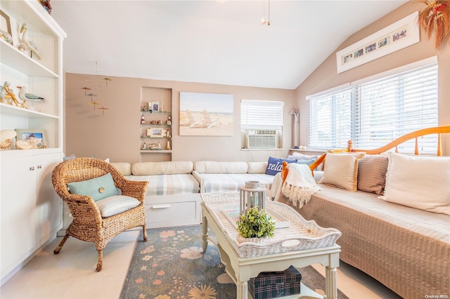 living room featuring cooling unit and lofted ceiling