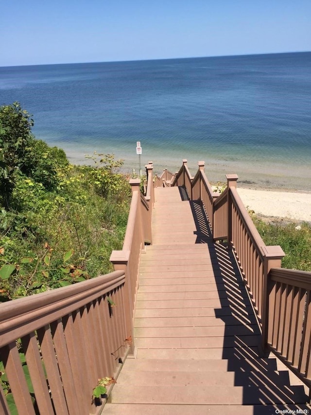 view of community with a water view and a view of the beach