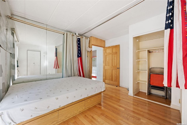 bedroom with hardwood / wood-style flooring