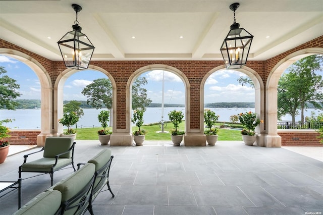 view of patio with a water view and an outdoor hangout area