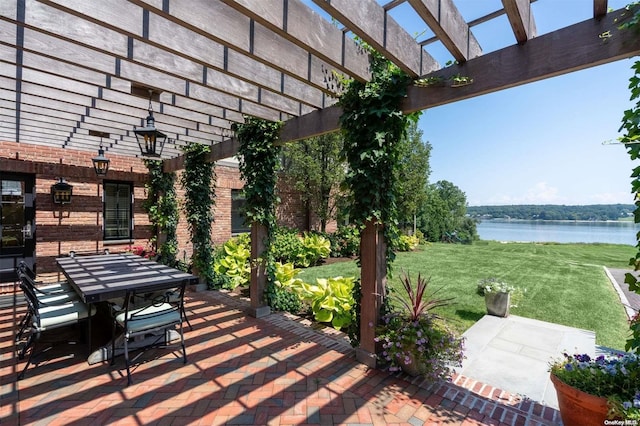 view of patio / terrace with a water view and a pergola