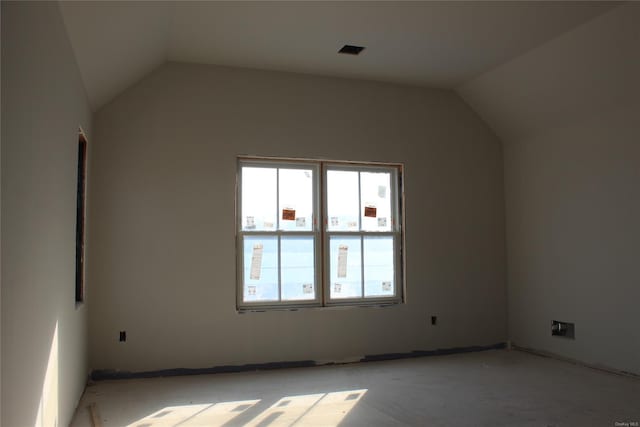 empty room featuring vaulted ceiling