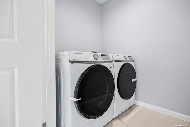 laundry room with separate washer and dryer and light tile patterned floors