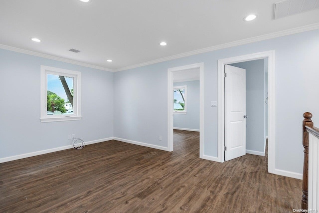 spare room with crown molding and dark wood-type flooring