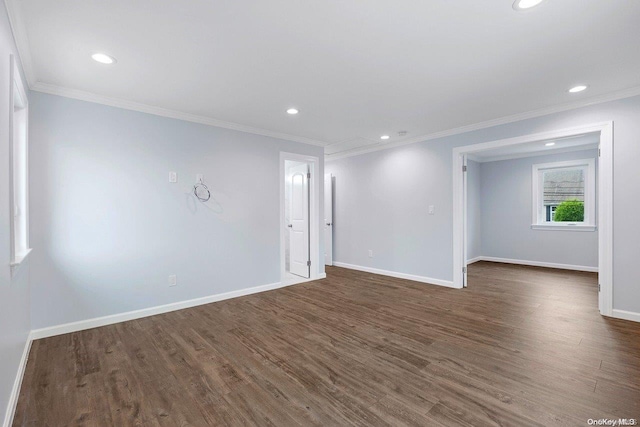 empty room with ornamental molding and dark wood-type flooring