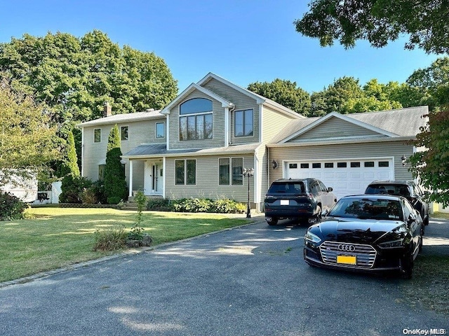 view of front of house with a front yard and a garage