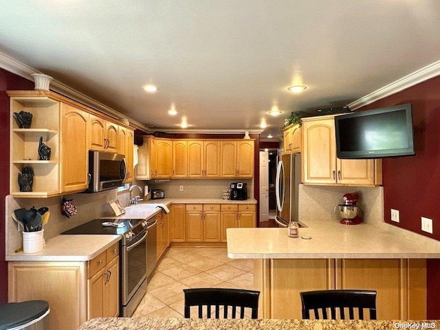 kitchen with sink, stainless steel appliances, kitchen peninsula, light brown cabinetry, and ornamental molding