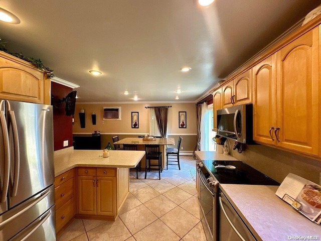 kitchen featuring light tile patterned floors, kitchen peninsula, ornamental molding, and appliances with stainless steel finishes