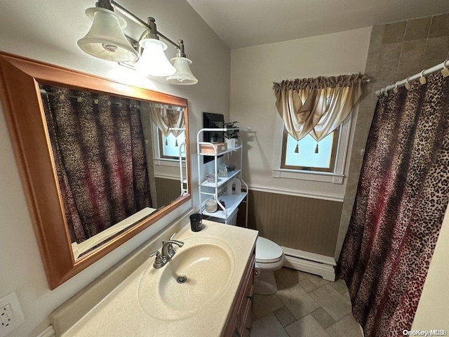 bathroom featuring vanity, toilet, and a baseboard heating unit