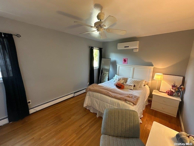 bedroom featuring a wall unit AC, ceiling fan, light hardwood / wood-style flooring, and baseboard heating