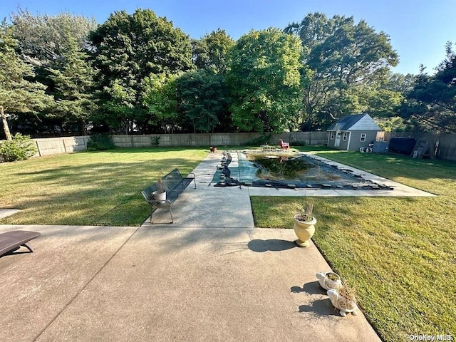 view of yard with an outdoor structure, a patio, and a covered pool