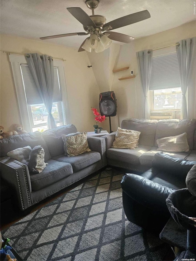 carpeted living room with a textured ceiling and ceiling fan