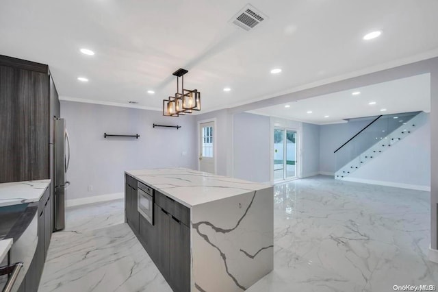 kitchen with light stone countertops, stainless steel appliances, crown molding, hanging light fixtures, and a large island