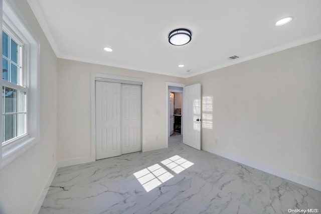 unfurnished bedroom featuring a closet and ornamental molding