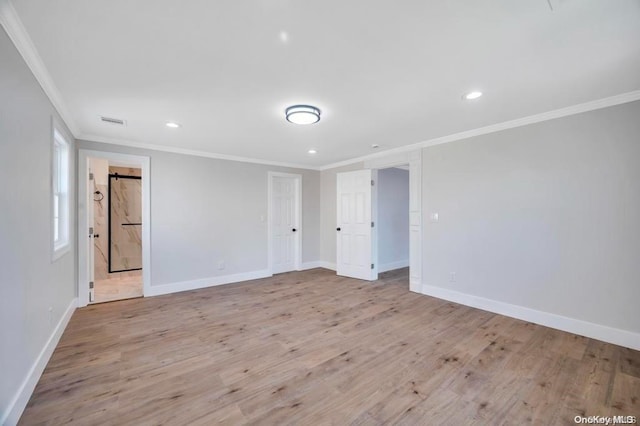 empty room featuring crown molding and light hardwood / wood-style flooring