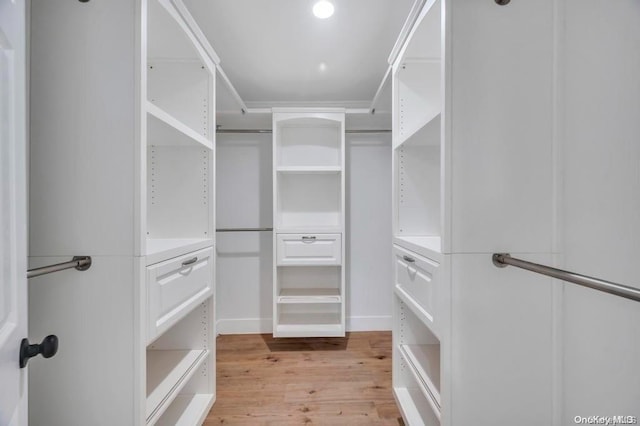 spacious closet with light hardwood / wood-style floors