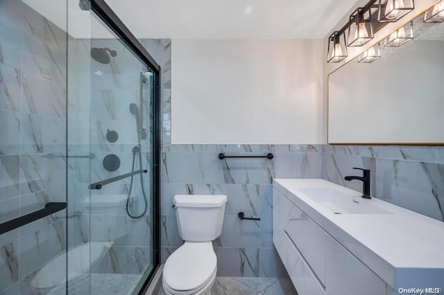 bathroom featuring vanity, toilet, tile walls, and walk in shower